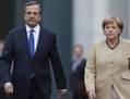 24 août 2012, Berlin, la chancelière allemande Angela Merkel et le Premier ministre grec Antonis Samaras  passe en revue une garde d’honneur pour l’arrivée du premier ministre grec à la Chancellerie. (Andreas Rentz/Getty Images) 
