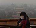 Pékin, 31-01-.2013, touriste chinoise photographiant le centre historique du Parc Jingshan, alors que le smog enveloppe la ville. Selon un rapport récent, Pékin souffre de surpopulation. (Mark Ralston/AFP/Getty Images) 