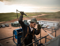 Un ouvrier sur un forage de puits de pétrole dans la formation de schiste de Bakken le 28 juillet 2013, près de Watford City, au Dakota du Nord. (Andrew Burton/Getty Images)