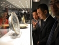 Le 24 septembre 2013, des visiteurs examinent la porcelaine chinoise avant la vente aux enchères chez Christie’s à Shanghai. Le mois dernier à Hangzhou en Chine, des inconnus franchissaient la clôture du chantier d’un site de construction pour déterrer de la porcelaine. (Peter Parks/AFP/Getty Images)
