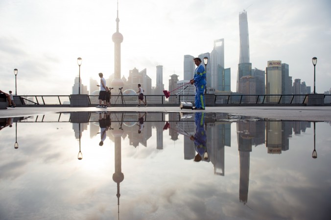 24 juillet 2014 : un ouvrier nettoie une promenade à Shanghai. Selon l’économiste He Qinglian, l’économie chinoise fait face à six grands problèmes. (Johannes Eisele/AFP/Getty Images)
