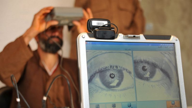 Un policier afghan regarde dans un scanneur biométrique rétinien. (U.S. Navy)