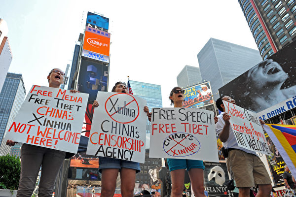 Les étudiants protestent contre  les écrans électroniques publicitaires installés à Times Square de New Yourk par l'agence officielle chinoise « Xinhua ». (Stan Honda / AFP / Getty Images)