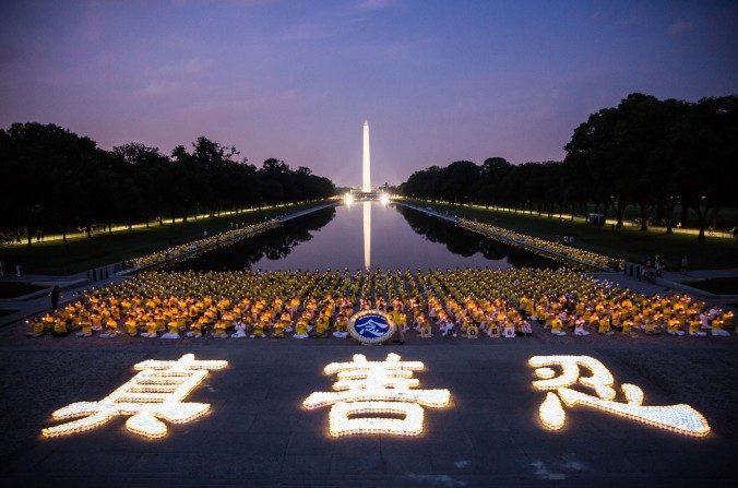 Des centaines de pratiquants de Falun Gong participent à une veillée aux chandelles à Washington, le 20 juillet 2017, en mémoire des victimes de la persécution lancée par le régime chinois le 20 juillet 1999. Les chandelles au premier plan forment les caractères chinois signifiant authenticité, bienveillance et tolérance - les trois principes de base du Falun Gong. (Benjamin Chasteen/The Epoch Times)