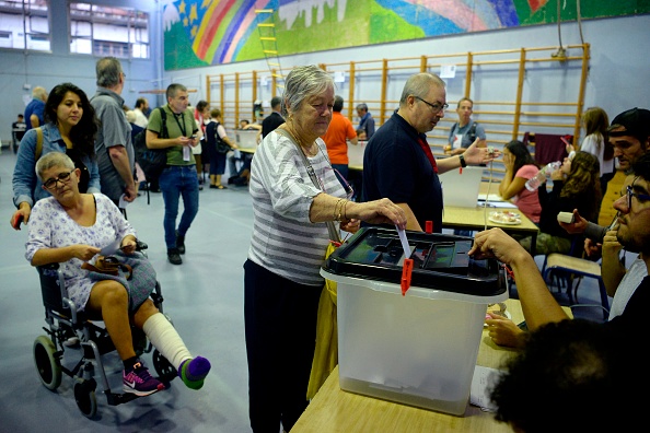 Une femme dépose son bulletin de vote à Barcelone, le 1er octobre 2017, lors du référendum sur l'indépendance de la Catalogne interdit par Madrid. Plus de 5,3 millions de Catalans ont été appelés à voter. 
(JOSEP LAGO / AFP / Getty Images)