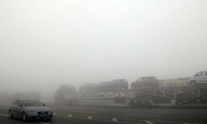 Des voitures arrêtées sur une autoroute à cause d'un dense nuage de pollution dans la province du Jilin, Chine, le 22 octobre 2013. (STR / AFP / Getty Images)