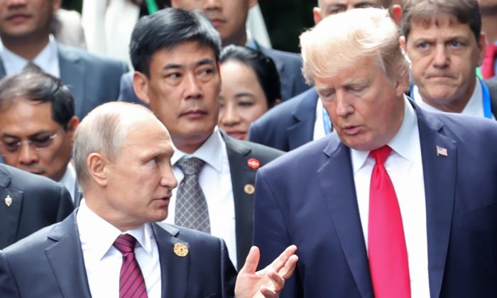 Donald Trump et Vladimir Poutine discutent avant la prise de la « photo de famille » lors du sommet des dirigeants de l’APEC à Danang, Vietnam, le 11 novembre 2017. (MIKHAIL KLIMENTYEV/AFP/Getty Images)