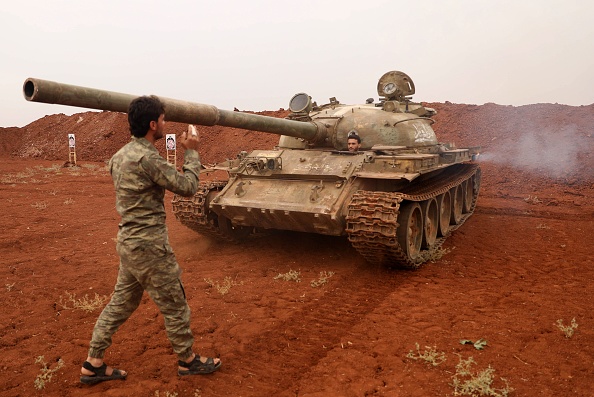 -Le 9 octobre 2018. Des combattants rebelles syriens du Front de libération nationale (FNL) sécurisent un char, une partie des armes lourdes et de l'équipement retirés hier d'une zone tampon prévue autour d'Idlib. Photo OMAR HAJ KADOUR / AFP / Getty Images.