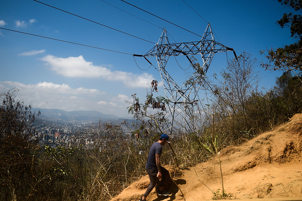 -Un homme se promène à côté de tours à haute tension sur la montagne de Waraira Repano, également appelée « El Avila », à Caracas, le 10 mars 2019. Dimanche est le troisième jour où les Vénézuéliens restent sans communication, sans électricité ni eau, dans une panne d'électricité sans précédent. Photo de FEDERICO PARRA / AFP / Getty Images.
