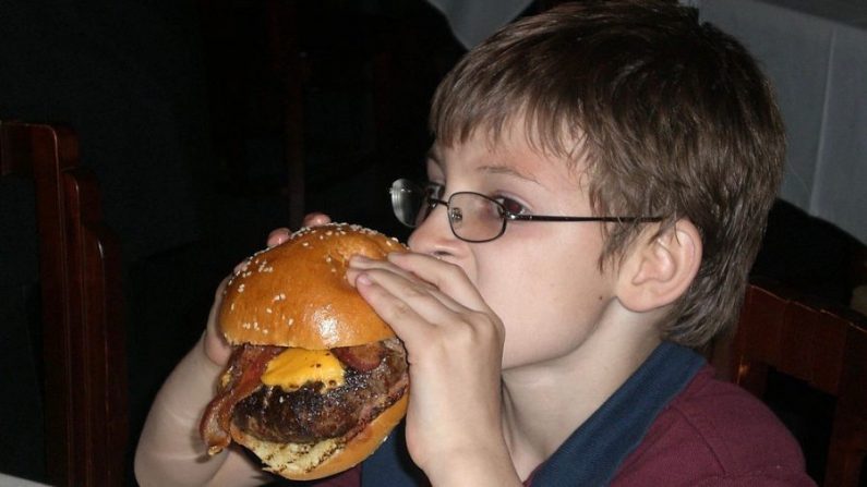 Eli Knauer, 10 ans, mange un cheeseburger au bacon deux fois plus large que son visage au Morton's Steakhouse de Baltimore, dans le Maryland, le 27 mai 2011. (Olivia Hampton / AFP / Getty Images)