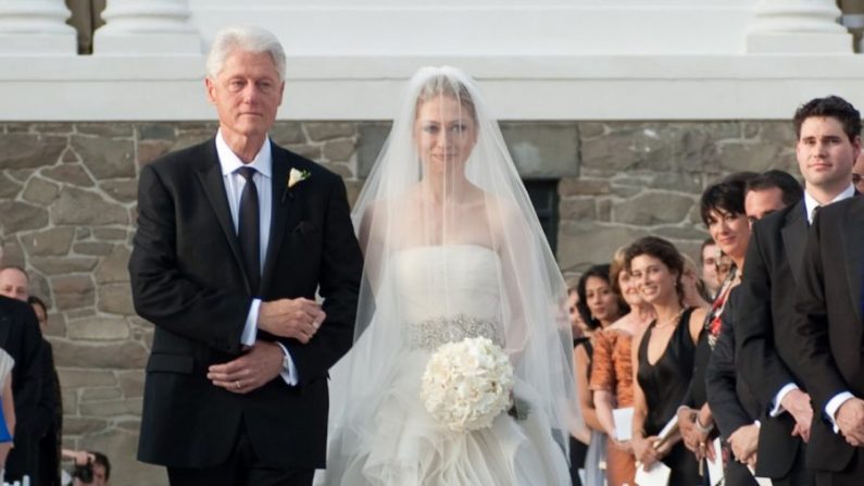 L'ancien président Bill Clinton (à gauche) accompagne Chelsea Clinton dans l'allée lors de son mariage avec Marc Mezvinsky au domaine Astor Courts à Rhinebeck, New York, le 31 juillet 2010. (Genevieve de Manio via Getty Images)