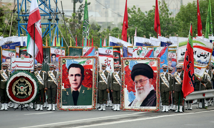 Des soldats iraniens portent les portraits du chef suprême iranien Ayatollah Ali Khamenei (à dr.) et de l'ancien chef d'état-major de l'armée iranienne Sepahbod Mohammad-Vali Gharani (à g.) lors du défilé militaire au Jour de l’armée, le 18 avril 2019, à Téhéran. (Stringer/AFP/Getty Images)