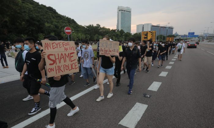 Des manifestants marchent sur une autoroute près de l'aéroport international de Hong Kong à la suite d'une manifestation contre la brutalité policière et le projet de loi controversé sur l'extradition le 12 août 2019. (Vivek Prakash/AFP/Getty Images)