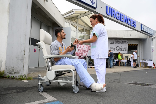 Un patient parle avec le personnel en grève au Centre hospitalier de Saint-Martin-de-Ré à La Rochelle le 12 juillet 2019. (XAVIER LEOTY/AFP/Getty Images)
