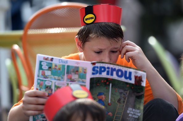 -Illustration- Un écolier lit un magazine de bandes dessinées belge, Spirou, lors de la "Fête de la BD" à Bruxelles, le 5 septembre 2014. Photo EMMANUEL DUNAND / AFP / Getty Images.