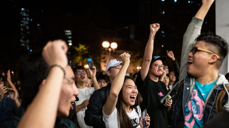 Les partisans de la démocratie chantent après que Junius Ho, candidat pro-Pékin, a perdu un siège aux élections du conseil dans le district de Tuen Mun de Hong Kong, début novembre 2019. (Philip Fong/AFP via Getty Images)