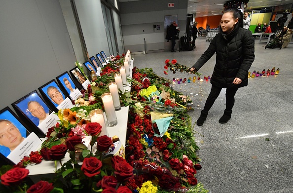 -Une femme dépose des fleurs sur un mémorial pour les victimes de l'accident du Boeing 737-800 d'Ukraine International Airlines, à l'aéroport de Boryspil près de Kiev le 8 janvier 2020. Photo de SERGEI SUPINSKY / AFP via Getty Images.