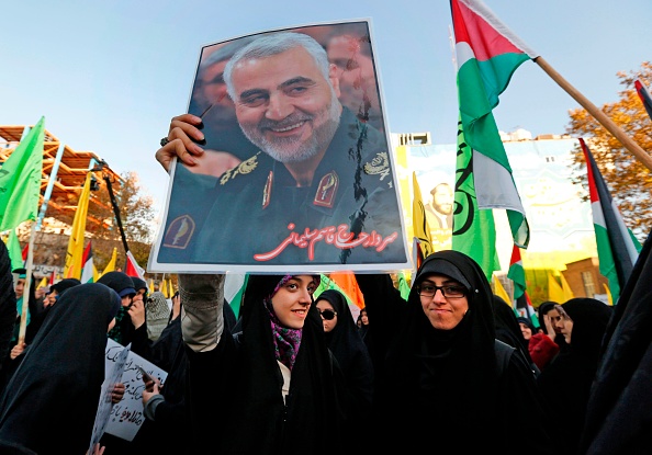 Des manifestants iraniens tiennent un portrait du commandant dirigeant des Gardiens de la Révolution, l'armée idéologique de la République islamique, Qassem Soleimani, lors d'une manifestation dans la capitale Téhéran le 11 décembre 2017. (Photo : ATTA KENARE/AFP via Getty Images)
