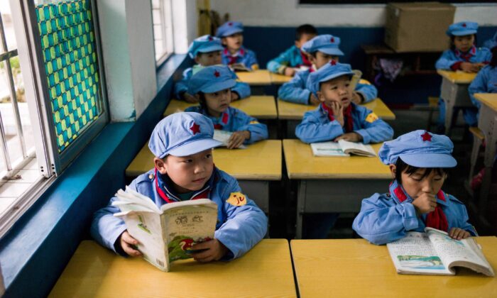 Des élèves lisent dans leur classe de l'école maternelle Yang Dezhi « Armée rouge » à Wenshui, canton de Xishui de la province du Guizhou, Chine, le 7 novembre 2016. En 2008, Yang Dezhi a été désignée « école primaire de l'Armée rouge », une école subventionnée par la « noblesse rouge » des commandants communistes chinois de l'époque de la révolution et les membres de leurs familles. Cette école est l'un des nombreux établissements de ce genre créés dans toute la Chine. Ils sont soumis à « l'éducation patriotique » que le Parti communiste au pouvoir en Chine promeut pour renforcer sa légitimité et sont condamnés par les critiques comme établissements de lavage de cerveau. (Fred Dufour/AFP via Getty Images)