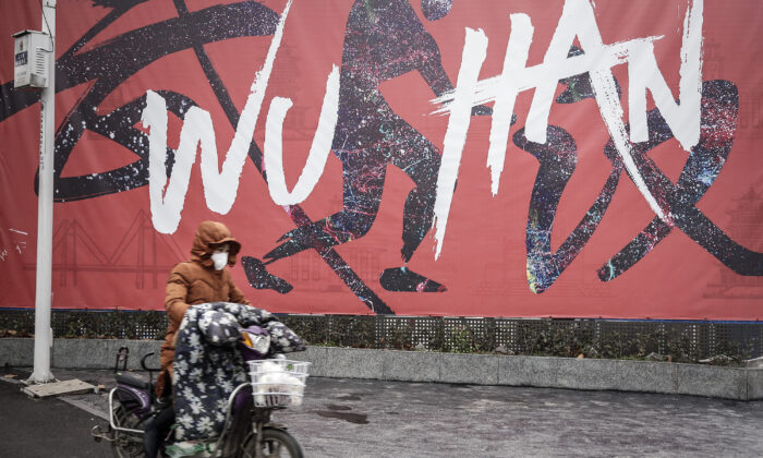 Une femme porte un masque alors qu'elle roule à bicyclette électrique à Wuhan, dans la province de Hubei, en Chine, le 22 janvier 2020. (Getty Images)
