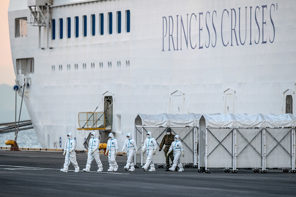 -Les travailleurs d'urgence en vêtements de protection quittent le bateau de croisière Diamond Princess à Daikoku Pier où il est réapprovisionné et les cas de coronavirus nouvellement diagnostiqués sont pris en charge. Photo de Carl Court / Getty Images.