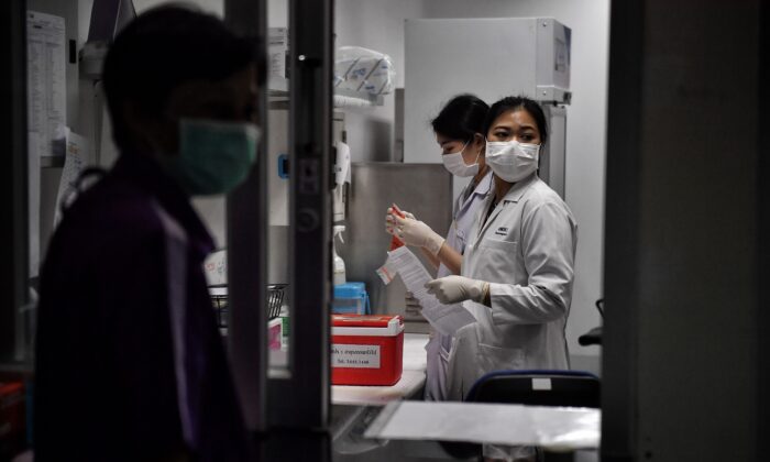 Des techniciens de laboratoire enregistrent des échantillons provenant de victimes potentielles du nouveau coronavirus au Centre des maladies infectieuses émergentes de Thaïlande de l'Université Chulalongkorn à Bangkok le 5 février 2020. (Lillian Suwanrumpha/AFP via Getty Images)
