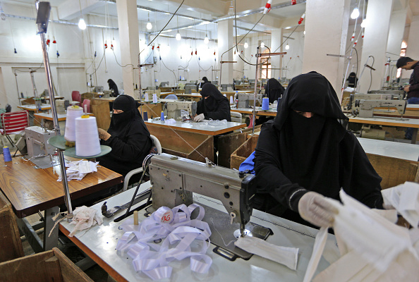 -Des femmes yéménites fabriquent des masques dans une usine textile de la capitale Sanaa, le 16 mars 2020. Photo par MOHAMMED HUWAIS / AFP via Getty Images. 