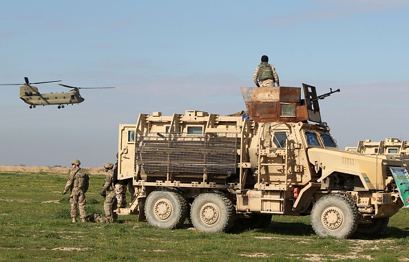 Military personnel arrive in a Chinook before Iraqi soldiers take part in a live-fire exercise for  under the surveillance of US-led coalition forces at Basmaya base, southeast of the Iraqi capital, Baghdad, on January 27, 2016. 


The US-led coalition's efforts to train the Iraqi military began in December 2014. Since then, more than 18,000 Iraqi troops have completed courses like the one held at the base in Basmaya. / AFP / AHMAD AL-RUBAYE        (Photo credit should read AHMAD AL-RUBAYE/AFP via Getty Images)