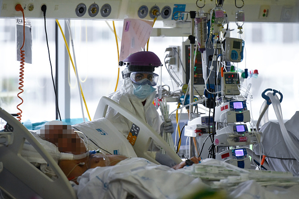-Un travailleur de la santé s'occupe d'un patient atteint de coronavirus à l'unité de soins intensifs de l'hôpital universitaire de La Paz à Madrid le 23 avril 2020. Photo par PIERRE-PHILIPPE MARCOU / AFP via Getty Images.
