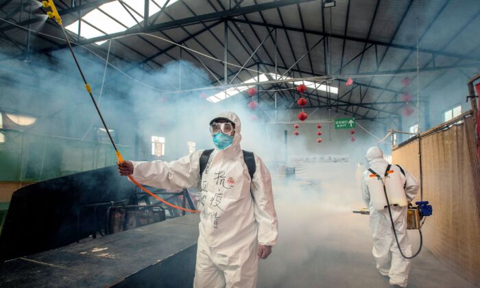 Le 6 mai 2020, du personnel pulvérise du désinfectant sur un marché de Suifenhe, à Heilongjiang, en Chine. 