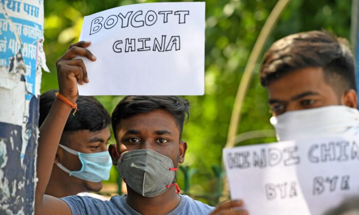 Des manifestants anti-Chine affichent des pancartes exhortant les citoyens à boycotter les produits chinois lors d'une manifestation à New Delhi le 18 juin 2020. (Photo par PRAKASH SINGH/AFP via Getty Images)