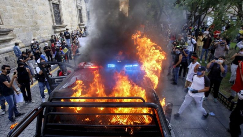 Des manifestants ont brûlé des véhicules de police lors d'une manifestation le 4 juin, à la suite du décès de Giovanni López, 30 ans, qui est mort en garde à vue après avoir résisté à son arrestation à Guadalajara, dans l'État de Jalisco, au Mexique, le soir du 4 mai 2020. (Ulises Ruiz/AFP/Getty Images) 