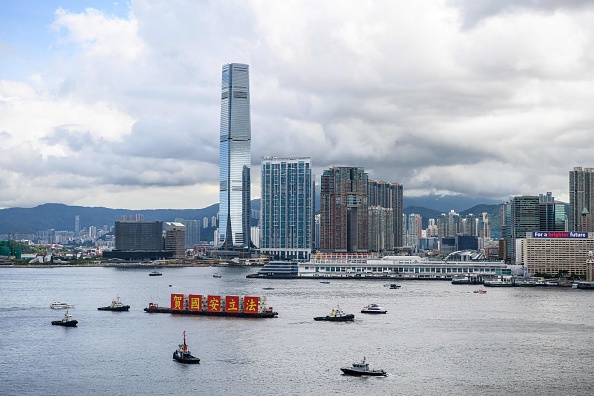-Une barge avec des bannières qui disent Célébrer la loi sur la sécurité nationale navigue dans le port de Victoria lors du 23e anniversaire de la passation de Hong Kong depuis la Grande-Bretagne à Hong Kong le 1er juillet 2020. Photo par Anthony WALLACE / AFP via Getty Images.