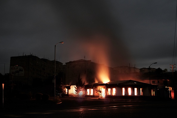 -Un bâtiment brûle après les récents bombardements lors des combats en cours entre l'Arménie et l'Azerbaïdjan dans la principale ville de la région contestée, Stepanakert, tôt le 4 octobre 2020. Photo par Areg Balayan / Gouvernement arménien / AFP via Getty Images.