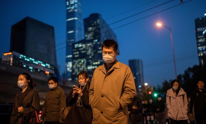 Des personnes masquées traversent une rue à Pékin le 21 octobre 2020. (Nicolas Asfouri/AFP via Getty Images)