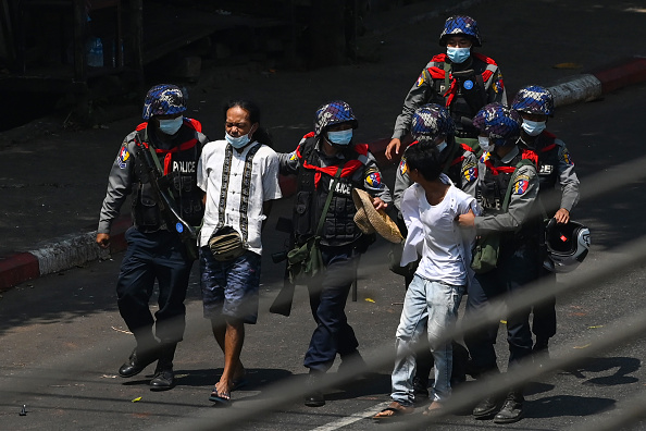 La police arrête des personnes à Yangon le 27 février 2021, des manifestants participant à une manifestation contre le coup d'État militaire. Photo par Sai Aung Main / AFP via Getty Images.