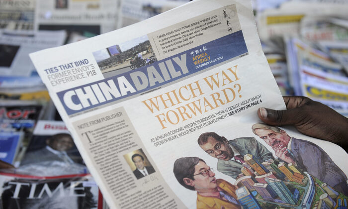 Un consommateur de journaux lit un exemplaire de l'édition africaine du quotidien chinois devant un kiosque à journaux dans la capitale kenyane, le 14 décembre 2012. (Tony Karumba/AFP via Getty Images)