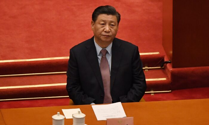 Le dirigeant chinois Xi Jinping assiste à la cérémonie d'ouverture de la Conférence consultative politique du peuple chinois au Grand palais du Peuple à Pékin, le 4 mars 2021. (Leo Ramirez/AFP via Getty Images)