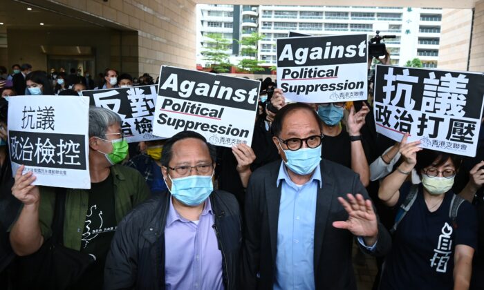 (G-D) Alberto Ho et Yeung Sum quittent le bâtiment du tribunal de West Kowloon après avoir été condamnés à des peines avec sursis à Hong Kong, le 16 avril 2021. (Song Pi-lung/The Epoch Times)