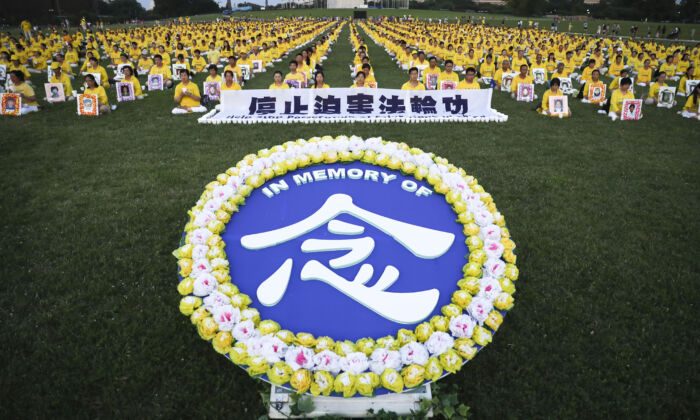 Des pratiquants de Falun Gong participent à une veillée aux chandelles commémorant le 20e anniversaire de la persécution du Falun Gong en Chine, sur la pelouse ouest du Capitole, le 18 juillet 2019. (Samira Bouaou/The Epoch Times)