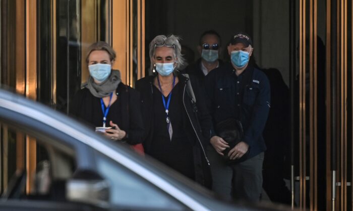 (L-R) Thea Fischer, Marion Koopmans, Peter Daszak and other members of the World Health Organization (WHO) team investigating the origins of the Covid-19 pandemic, leave the Hilton Wuhan Optics Valley Hotel in Wuhan, on Jan. 29, 2021. (HECTOR RETAMAL/AFP via Getty Images)
