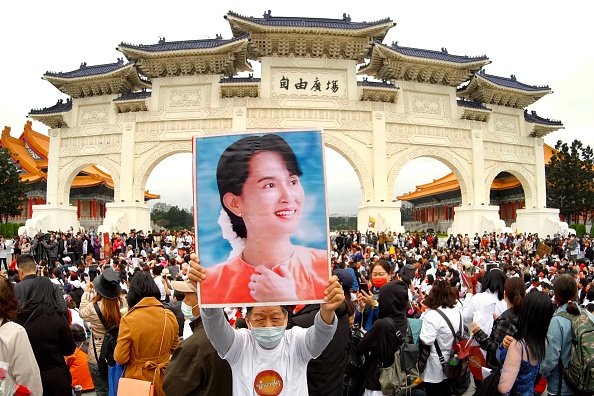 -Un homme du Myanmar vivant à Taïwan affiche un portrait de son ancienne dirigeante Aung San Suu Kyi à Taipei le 21 mars 2021. Photo de Sam Yeh / AFP via Getty Images.