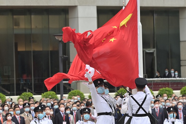 -Les drapeaux chinois et hongkongais lors d'une cérémonie de lever de drapeau marquent le 24e anniversaire de la rétrocession de Hong Kong à la Grande-Bretagne le 1er juillet 2021. Photo de Peter PARKS / AFP via Getty Images.