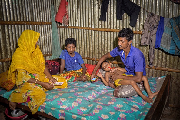 -La réfugiée climatique Bibi Salma est avec sa famille dans sa maison temporaire dans un bidonville à Dhaka le 19 septembre 2021. Photo par MUNIR UZ ZAMAN/AFP via Getty Images.