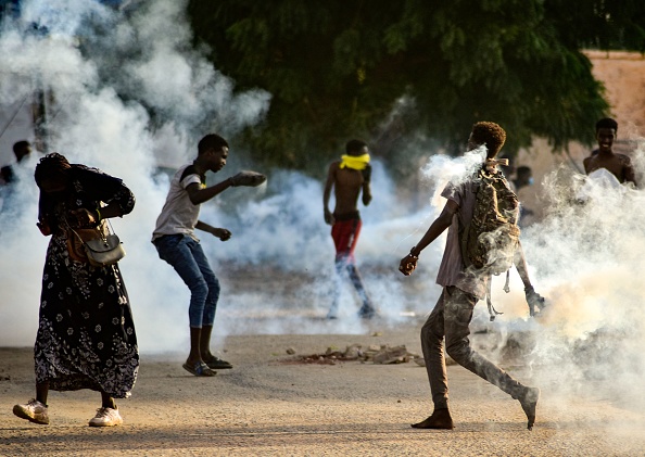  Des jeunes soudanais affrontent les forces de sécurité au milieu des gaz lacrymogènes qu'elles ont tirés pour disperser les manifestants dans la capitale Khartoum, le 27 octobre 2021. Photo de -/AFP via Getty Images. 