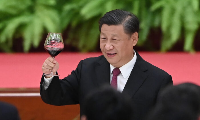 Chinese President Xi Jinping raises his glass after a speech by Premier Li Keqiang at a reception at the Great Hall of the People in Beijing on the eve of China's National Day on September 30, 2021. (Photo by GREG BAKER / AFP) (Photo by GREG BAKER/AFP via Getty Images)
