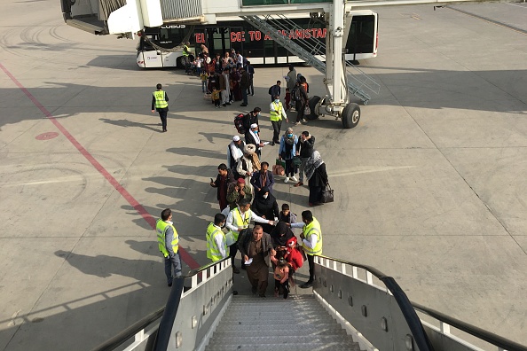 -Illustration- 396 Afghanes et Afghans à mettre en protection ont été évacués sur 10 vols distincts organisés par le Qatar vers la France. Photo de Hoshang HASHIMI / AFP via Getty Images.