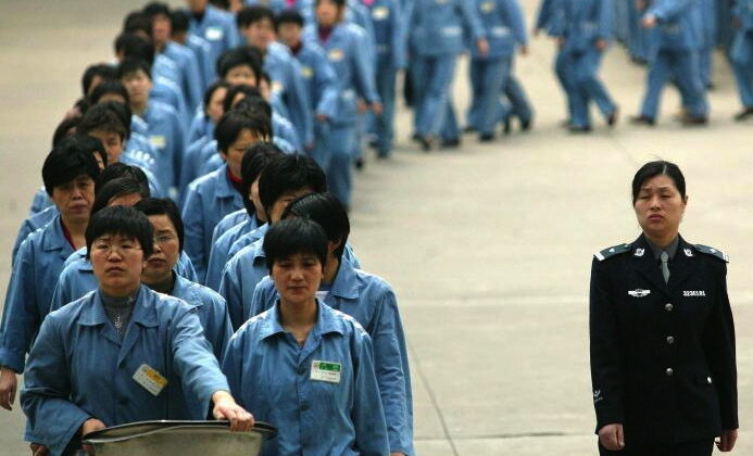 Des prisonnières marchent à côté d'une escorte de police lors de la journée portes ouvertes d'une prison à Nanjing, en 2005. (STR/AFP/Getty Images)