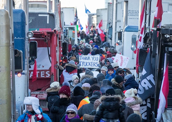Des manifestants arrivent sur la colline du Parlement pour le convoi de camions de la liberté afin de protester contre les  les restrictions sanitaire et la vaccination obligatoire  contre le Covid-19 à Ottawa, Canada, le 29 janvier 2022. (Photo : LARS HAGBERG/AFP via Getty Images)