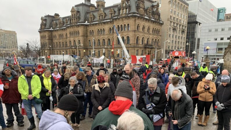 Des manifestants prient en face du parlement du Canada alors qu'ils se rassemblent à Ottawa pour manifester contre les obligations et les restrictions liées au Covid-19, le 17 février 2022. (Jonathan Ren/Epoch Times)